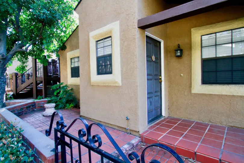 A small porch of a small house with a small garden in the Los Quatros condos community