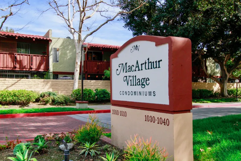 wall haveing lettesw MacArthur Village in MacArthur Village
