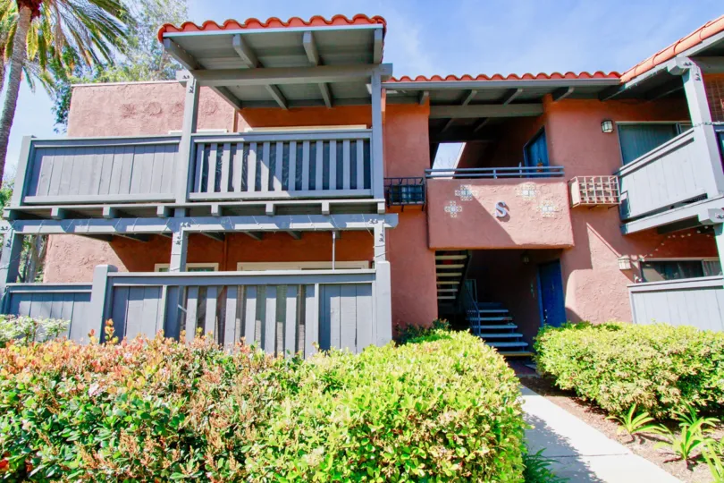 Red-and-blue front exterior of the Monterey Villas in Santa Ana, California