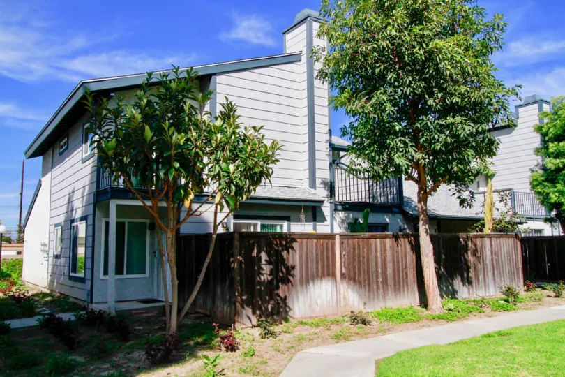 A corner house with large trees outside its compound in the Mountain view community