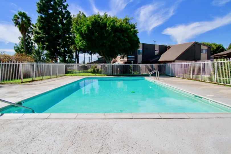 A great day in the Newhope Garden with a swimming pool and blue sky.