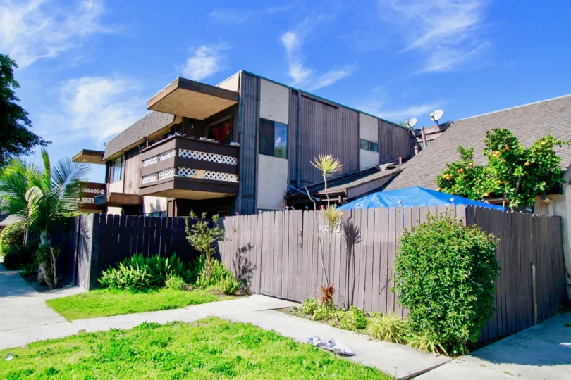 A clear day in the Newhope Garden in front of a modern building with lawn.