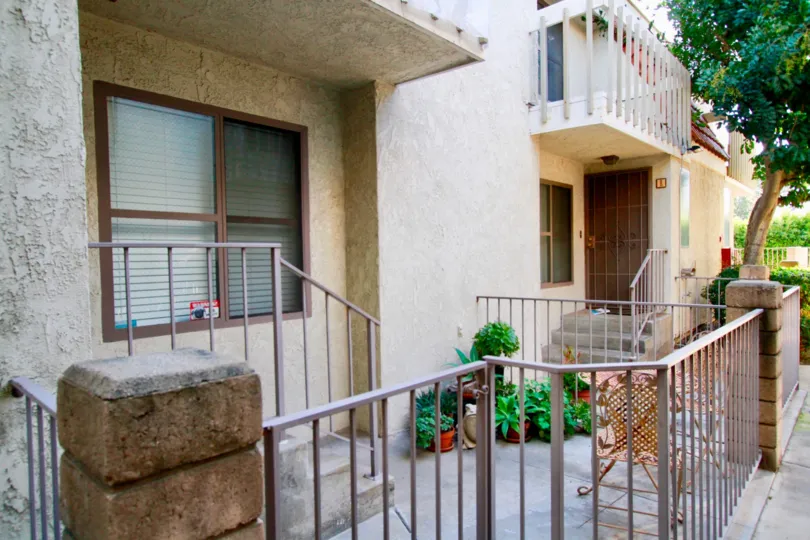 A groping of potted plants sit on a patio at North Broadway Townhomes