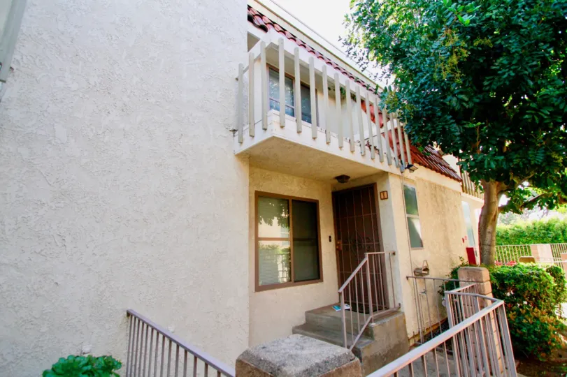 A house in Santa Ana, California with the front door and 2 floor balcony visible
