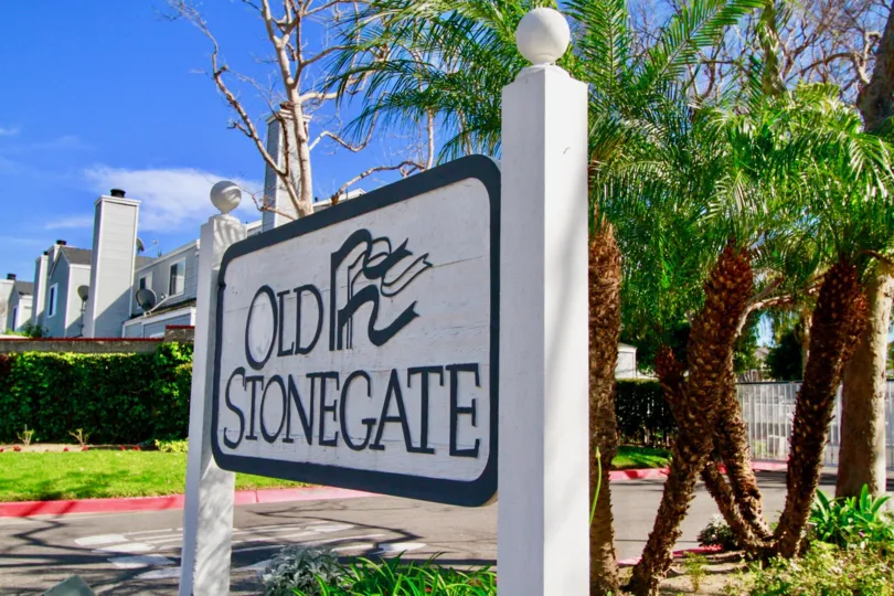 Old Stonegate board is placed near the entrance with plants and lawn