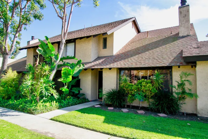 A home in Park Glen with trees and other plants on a sunny day.