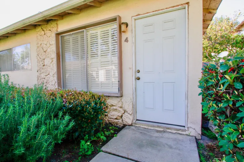 A beautiful day in the Regency Villas in front of the door and plants.