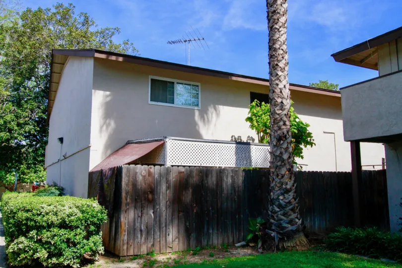 A great day in the Saddlebark Park Villas with a palm tree and building.