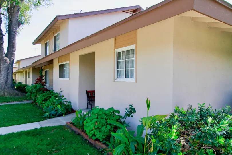 A well trimmed lawn outside small row houses in the Saddlebark park villas community