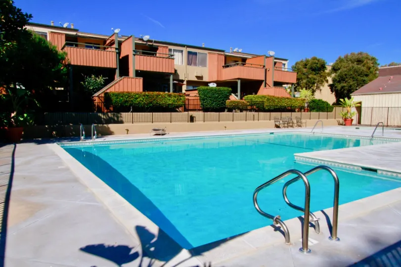 A clear day in the South Coast Terrace with a swimming pool with decorated plants.