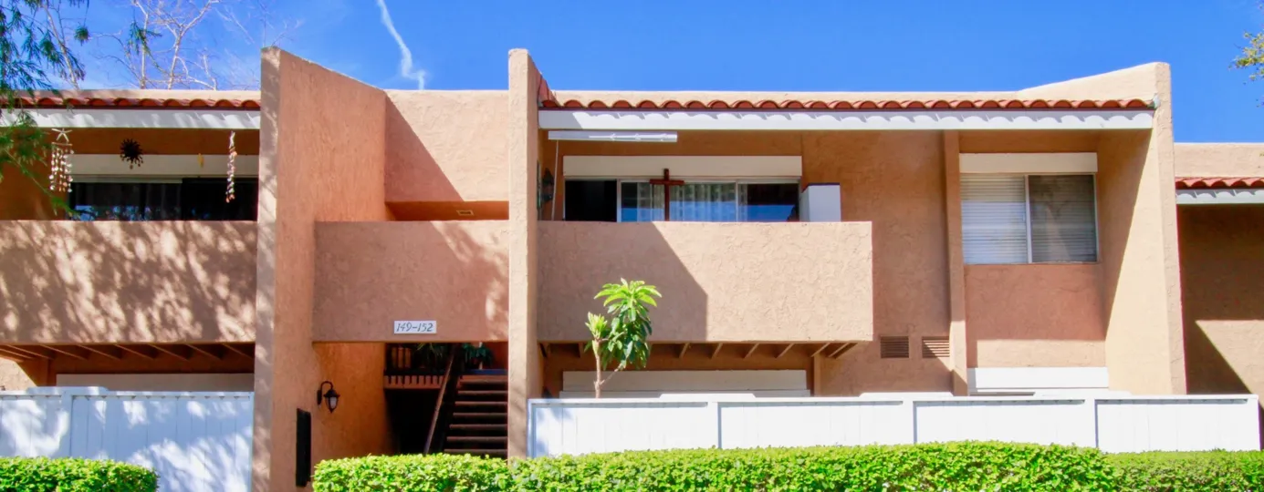 Peach Pastel exterior of the South Coast Villas, Santa Ana, California with blue skies