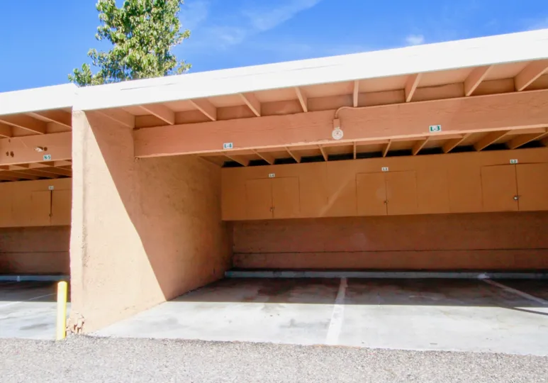 At car parking shed, Places are divided by white color paint and has separate cupboards for each parking in south Coast Villas
