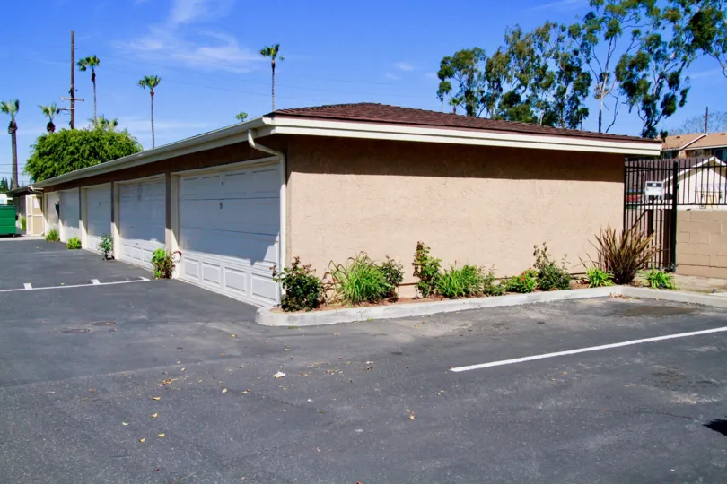 The entrance to the Summer Green community with a wide drive way and a series of garages