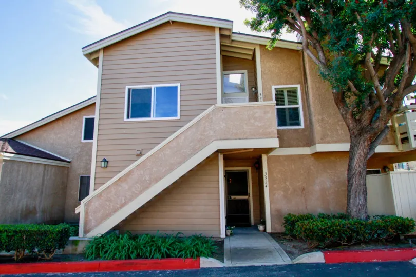 Outer View of a home in Summer Green Community with view of garden and stair case.