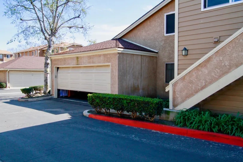 A large villa at a corner with a large garage and a staircase inside the Summer Green community