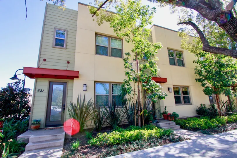 A apartment building in The Lacy Collection communty with trees and plants.