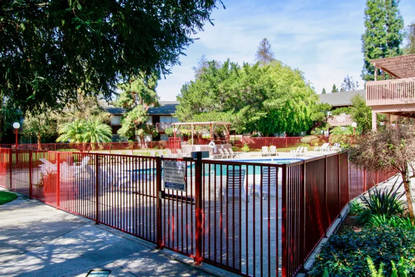 pool inside the compound gate decorated with chairs and tables around in The Redwoods
