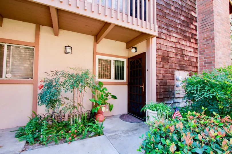 Before the door of villa in The Redwoods has flower pots and flag is placed between the bushes