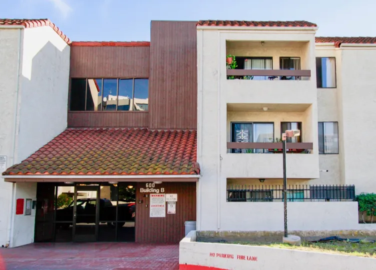 Balcony of the villa in Town Square has flower pots and chairs with light lamp and Notice board