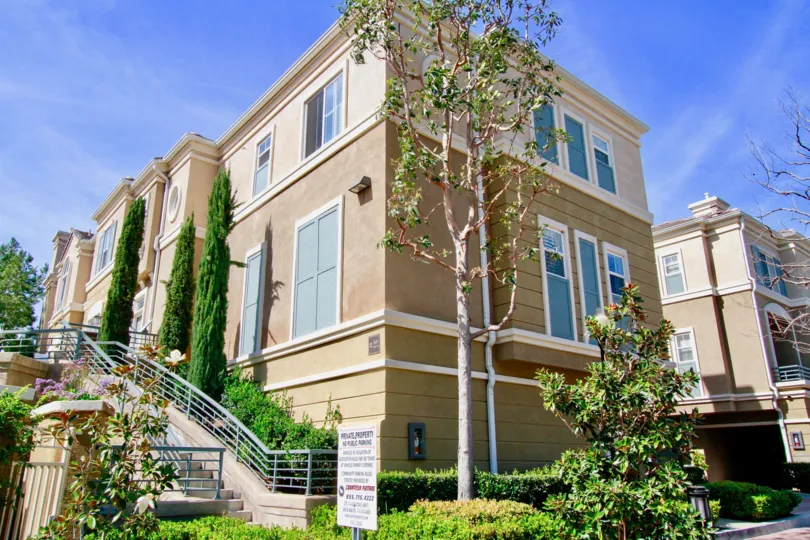 Vantage Santa Ana California is having traditional building and plants seems to touch sky with blue glass windows