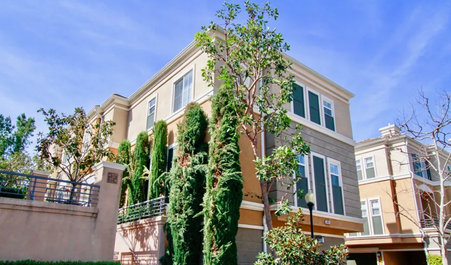 The sunny day in the Vantage with hotel rooms and gardens.