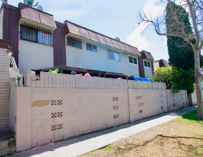 compound wall in front of the building and having trees and plants in Villa Fenix