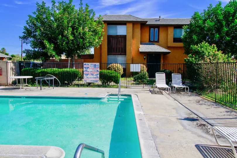 A great day in the Westvale Townhomes with a swimming pool and chair.