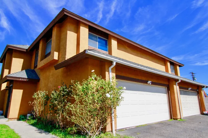 Grasses and bushes are grown which is attached to the wall of villa in Westvale Townhomes