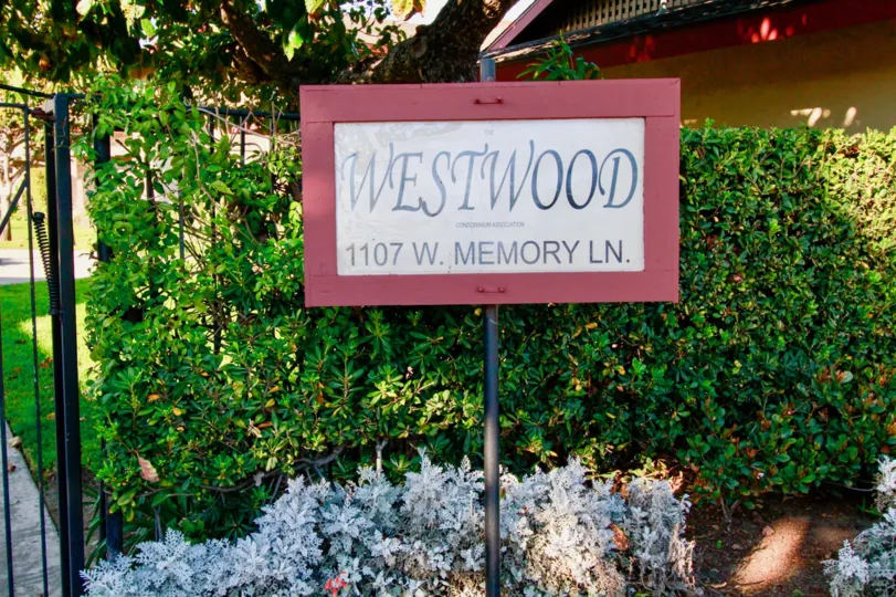 Back to the board of Westwood condos has lawn with cutting bushes and plants