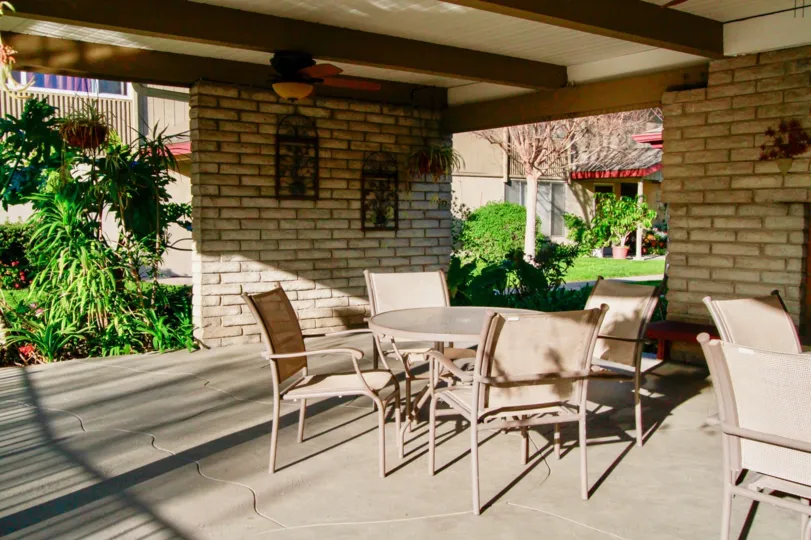 A nice day in the Westwood Condos with a table and some chairs.