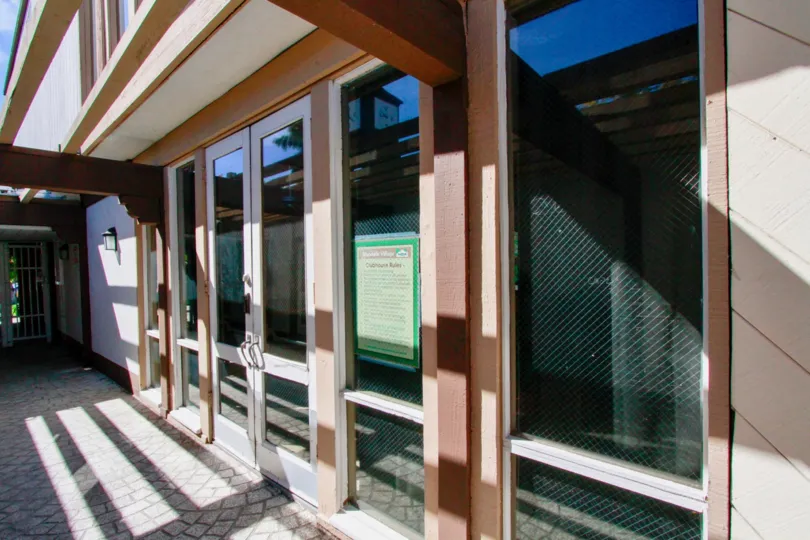 Sunlight is reflected in the door of Woodside Village with light lamp is attached in it