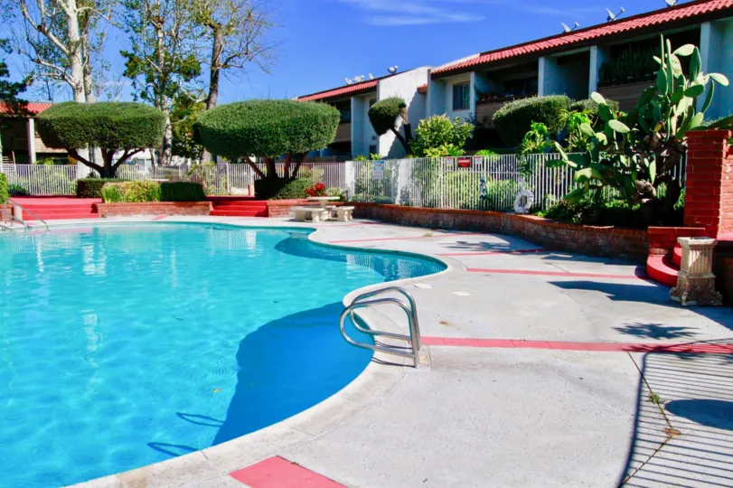 A sunnyday in the swimming pool with trees in woodside evillage