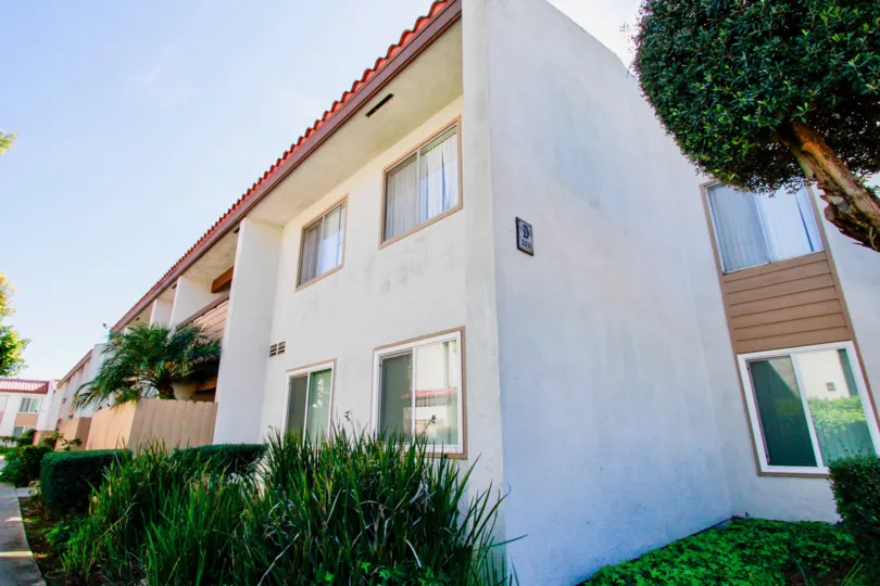 The sunny day in the Woodside Village with villas and gardens.