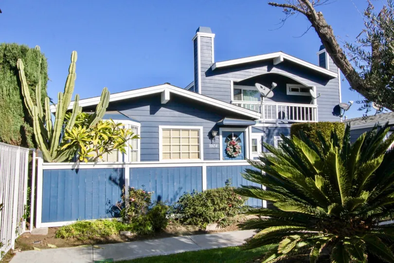 A beautiful blue color house in the Bell Cove with some plants.