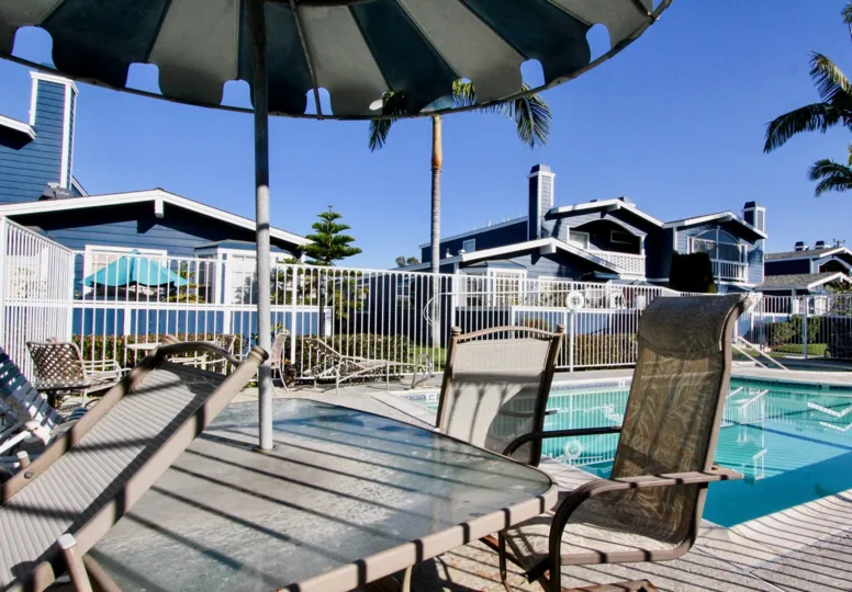 A sunny day in the Bell Cove with some chairs nearby the swimming pool in the Bell Cove.
