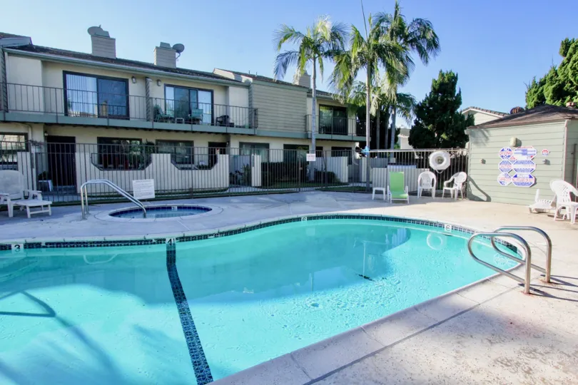 A view of the apartment complex community area of Cerritos Gardens focused on its pool and jacuzzi