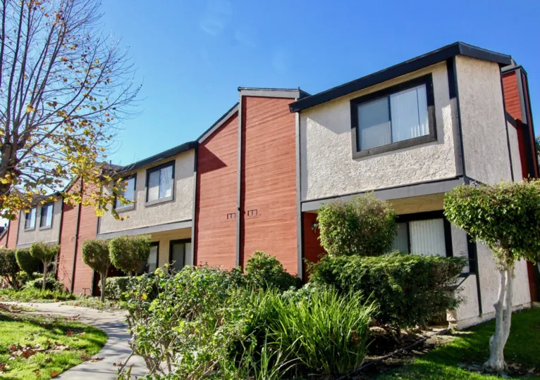 Brick color elevation at out side of the building with glass windows in Chapman Villas.