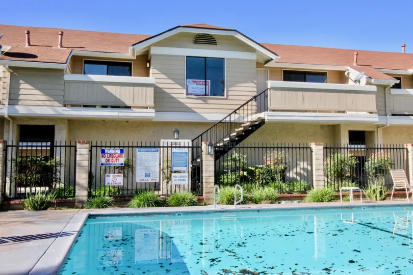 Fenced pool area with adjacent units at the Crosspointe Village
