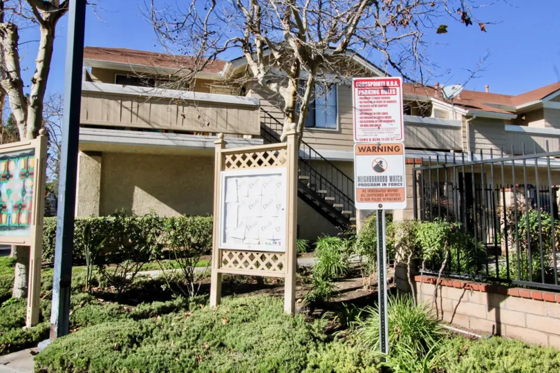 Double stored home with lawn and railing in Crosspointe Village.