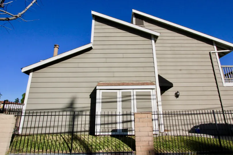 Side view of a duplex building with slanting roof and iron fencing in Park Villas.