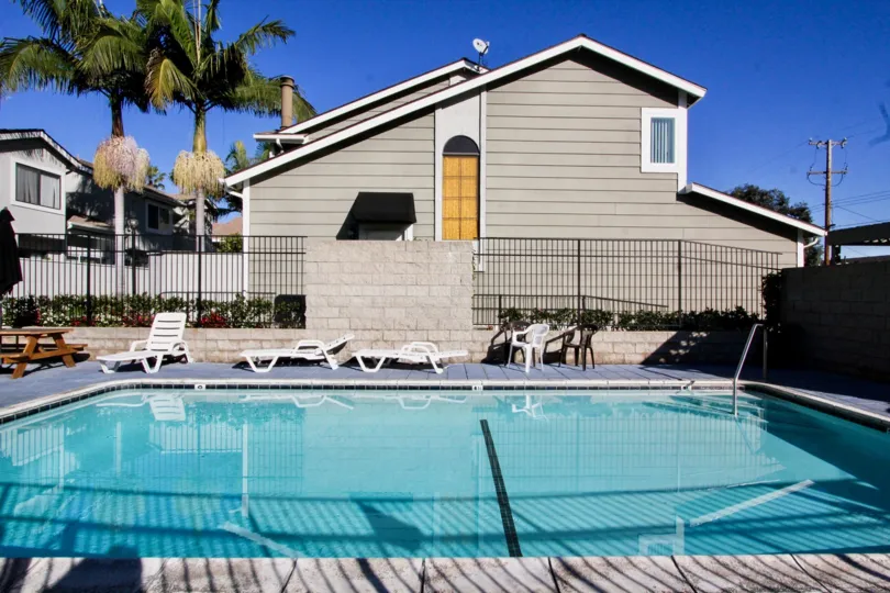 THE HOUSE IN THE PARK VILLAS WITH THE SWIMMING POOL, CHAIRS, TREES, DISH ANTENNA