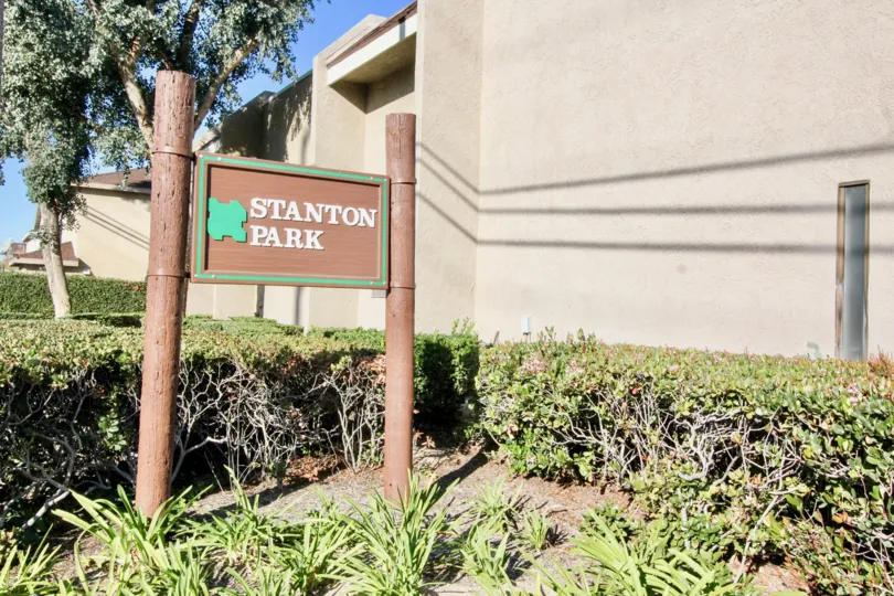 THE SIDE OF THE HOUSE IN THE STANTON PARK TOWNHOMES WITH THE PLANTS, TREES