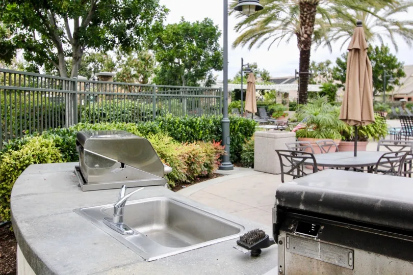 Common area pool with BBQ and outdoor cooking facilities at the Ainsley Park community