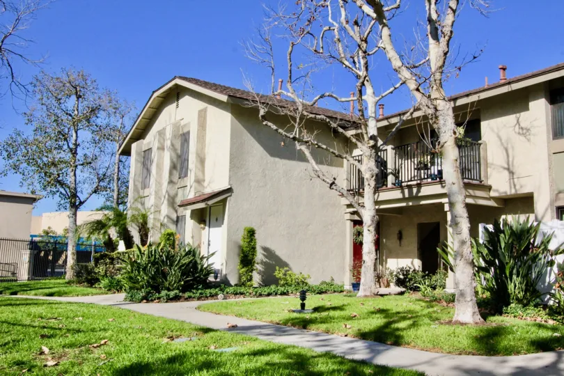 Fabulous view of green lawn with trees and balcony in Briarcliff Village of Tustin