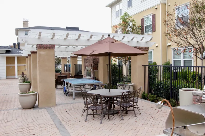 This image represents the restaurent which have the lot of chairs tables and the backside beautiful garden like place are there in the city of Tustin