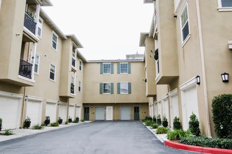 Garage doors line the walls of a condo building at the Cambridge Lane community
