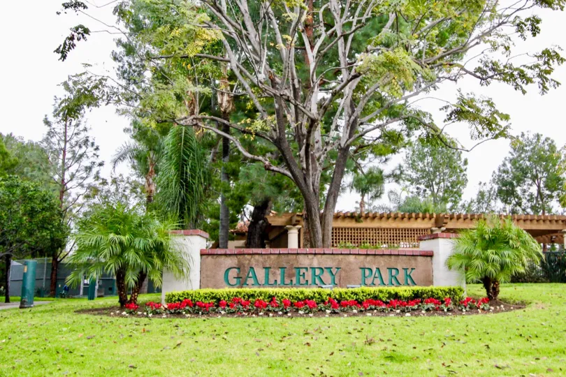 Awesome view of park area with lawn and board with trees in Corte Villa of Tustin