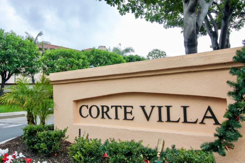 "Corte Villa" is written in black on a sign at the Corte Villa condos