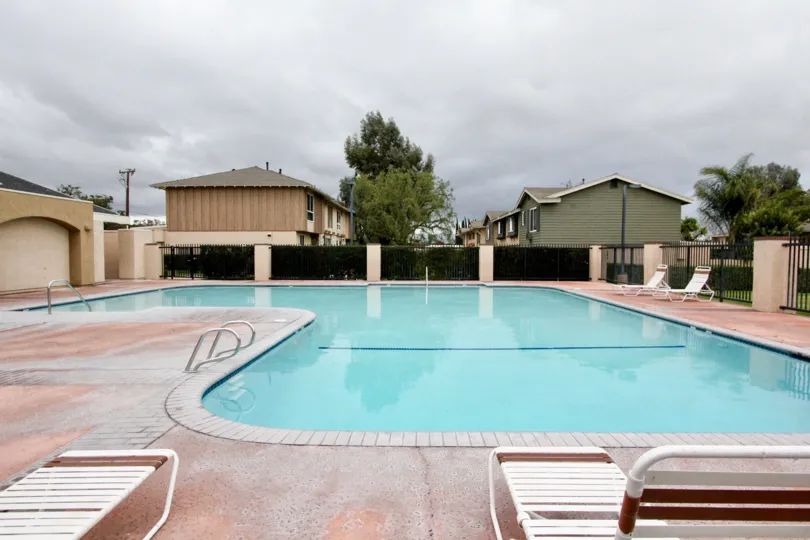 THE FLATS IN THE Influential Square WITH THE SWIMMING POOL, FOUR CHAIR, PLANTS, TREES