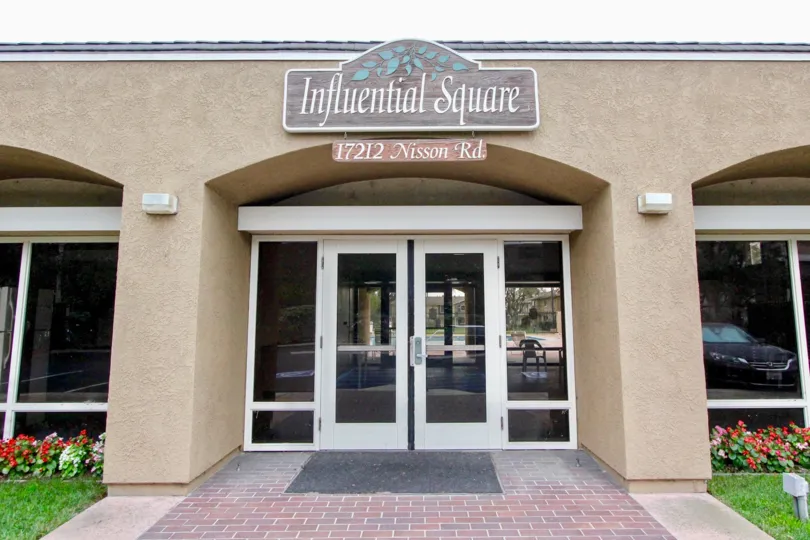 This image represents looks like the hotel which have the name board Influential Square is located in 17212 Nisson Rd in the city of Tustin CA